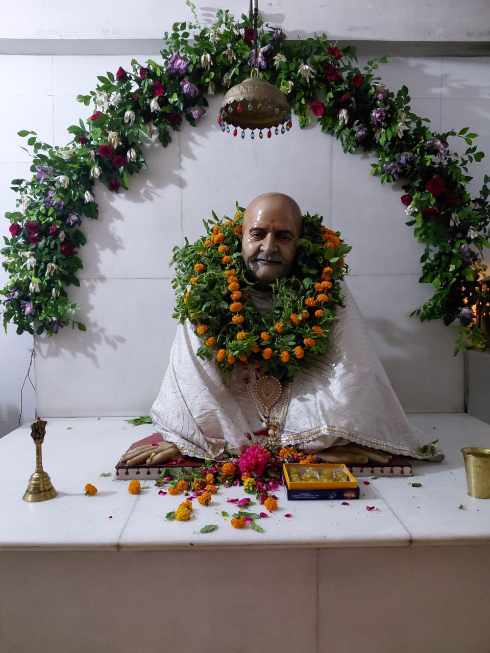 Devotees in quiet devotion and prayer inside the main sanctum hall